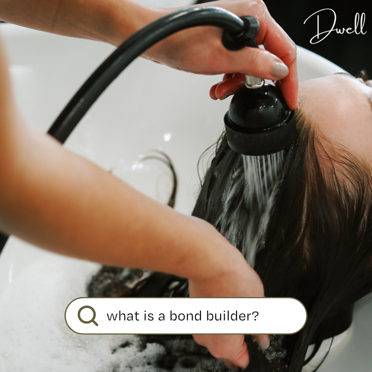 Close-up of a client receiving a bond builder hair treatment at a salon shampoo sink, with a search bar graphic asking "what is a bond builder?".