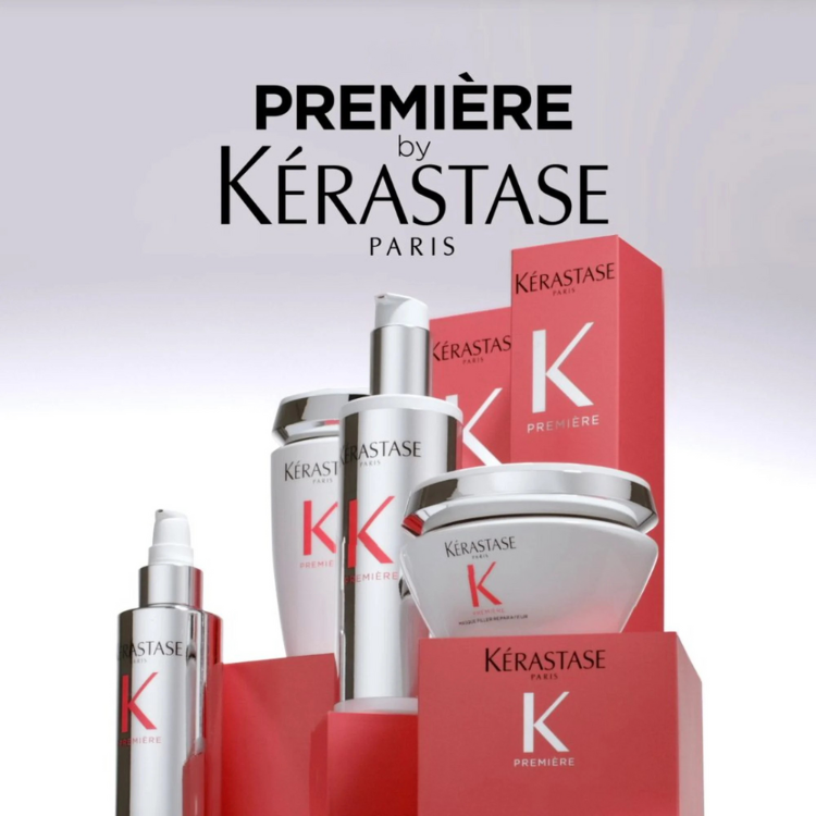 Kérastase Première hair care repair products display on red pedestals.