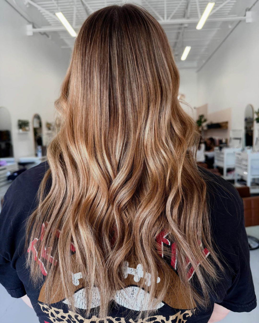 Long dimensional blonde and brown hair featuring two rows of sew-in extensions by Jessica.