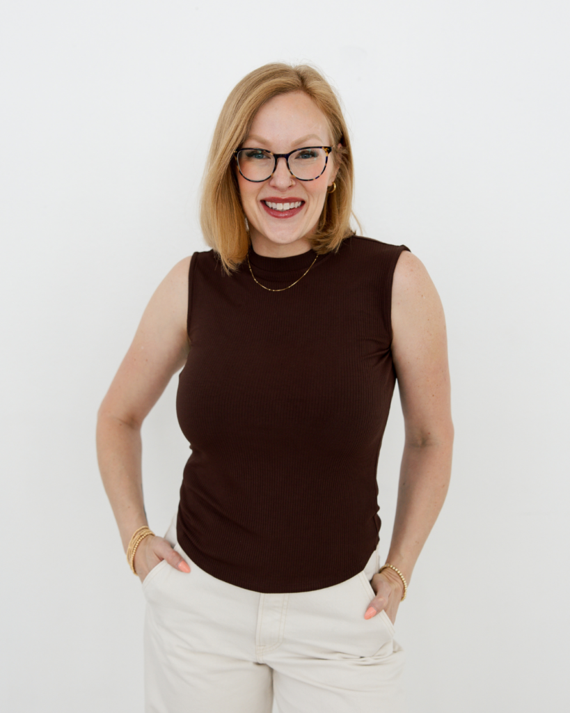 Salon owner Angela Wall wearing glasses and brown top at Fort Worth Texas salon.