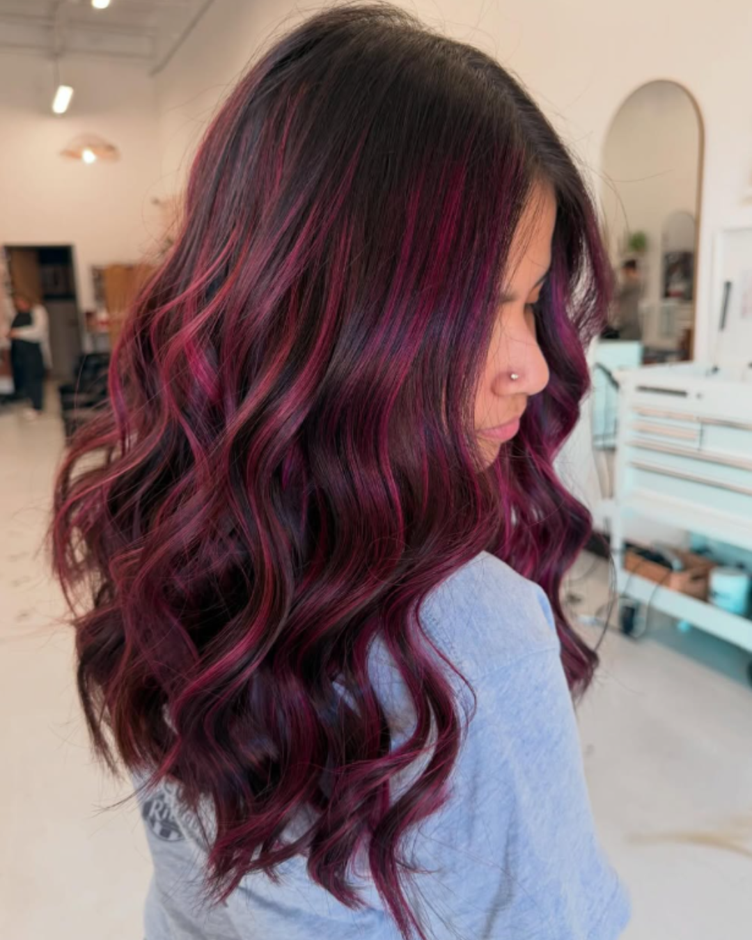 Vivid fuchsia and dark pink balayage hair coloring on wavy hair by Jessica.