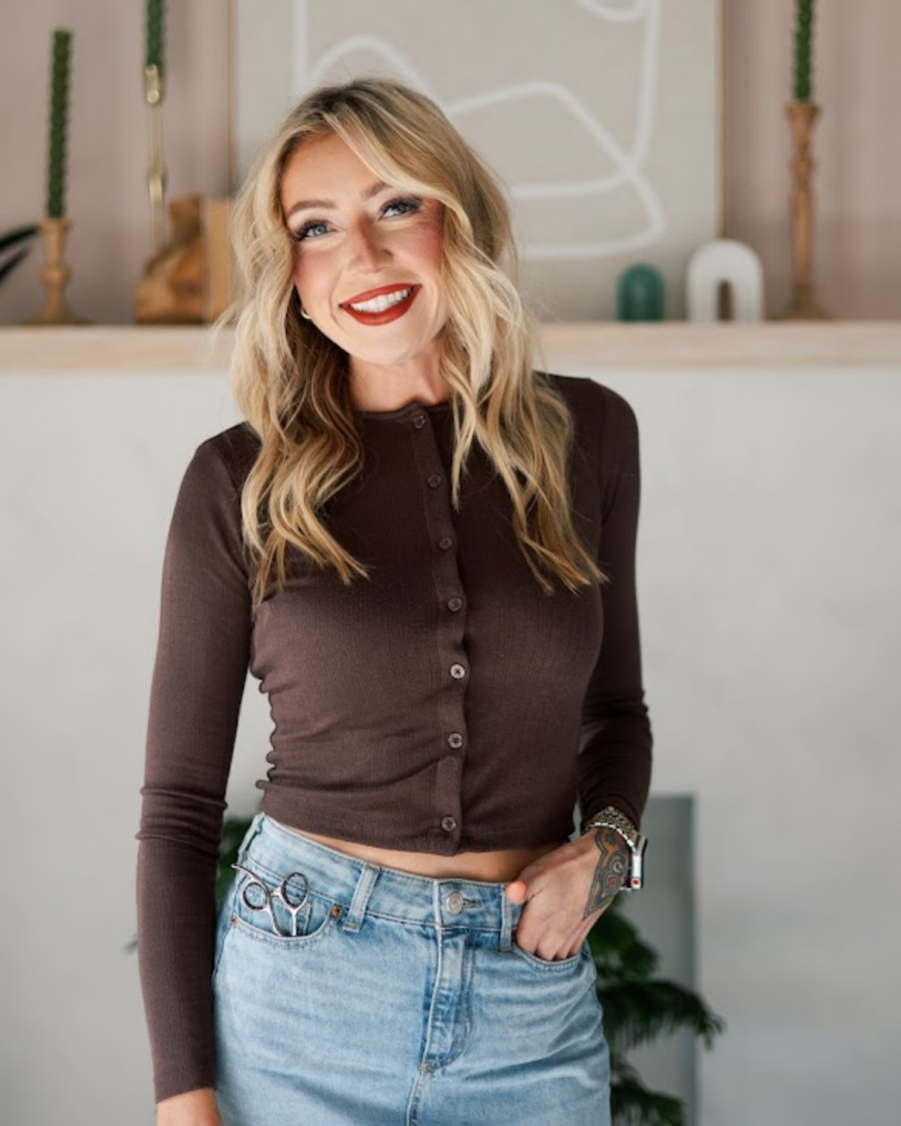Shelby Baldwin, hair cutting specialist in Fort Worth, Texas, smiling indoors.